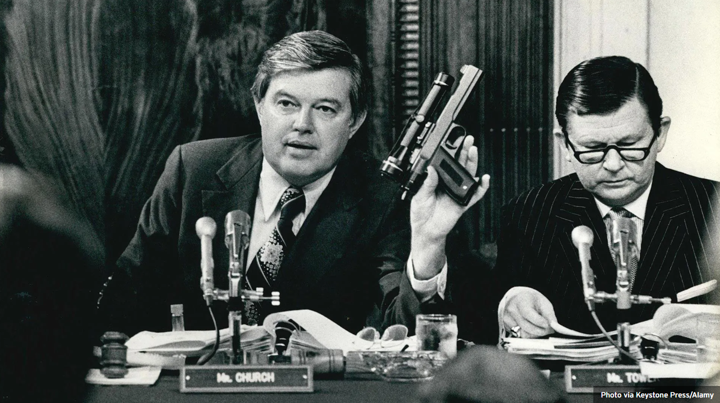 Senator Frank Church holding the CIA's so-called 'heart attack gun' during a 1975 committee hearing