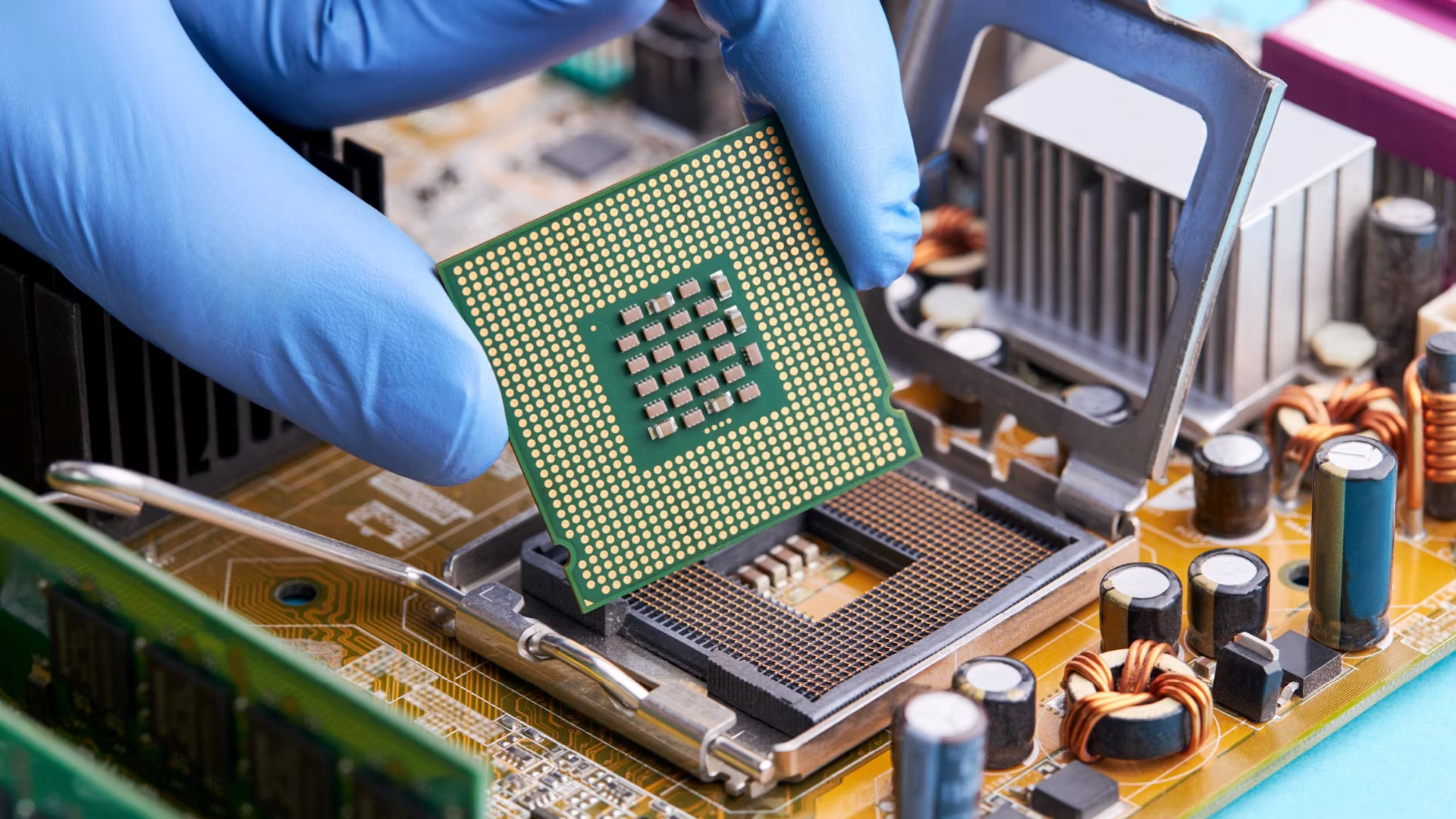 Technician installing a semiconductor processor onto a motherboard