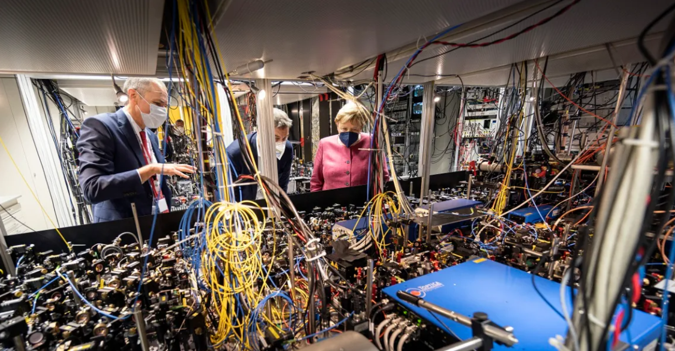German Chancellor Angela Merkel and Bavaria State Premier Markus Soeder visit the Max Planck Institute of Quantum Optics to see how a quantum computer works, guided by Institute manager Immanuel Bloch in Garching, Germany, 2021.