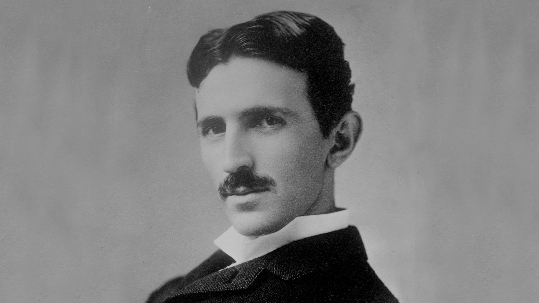 A photograph image of Nikola Tesla.
